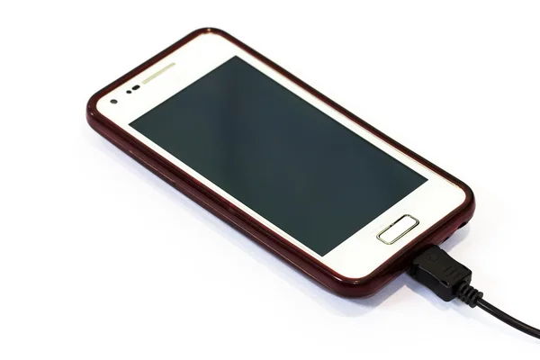 Carregamento de telefone celular isolado no fundo branco — Fotografia de Stock