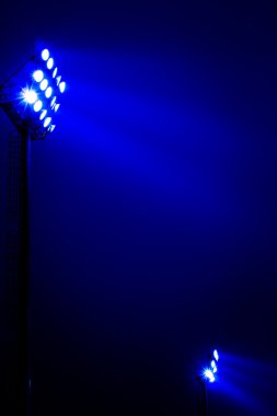 Stadium floodlights on a sports field at night  clipart