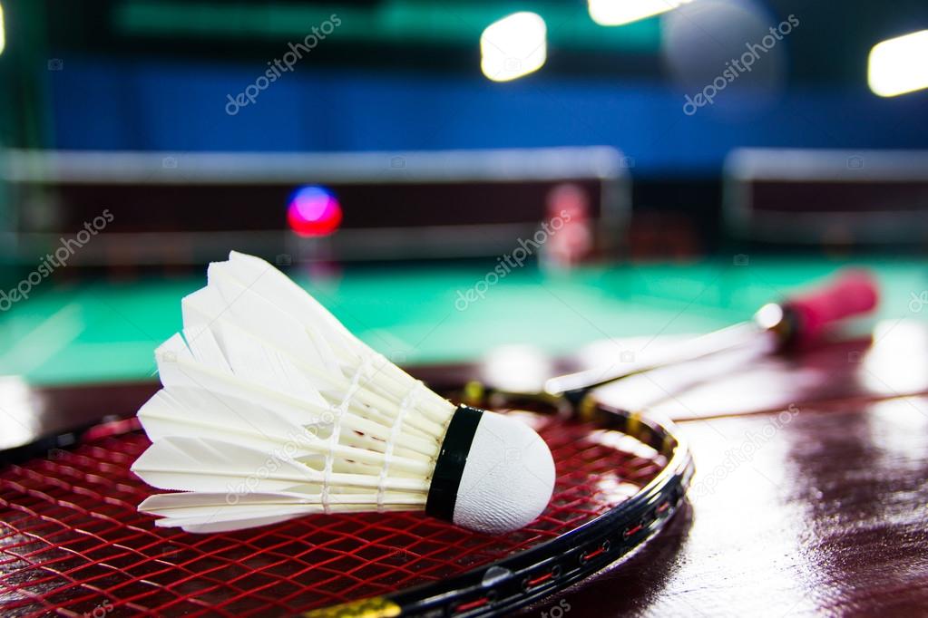 shuttlecock on badminton rackets