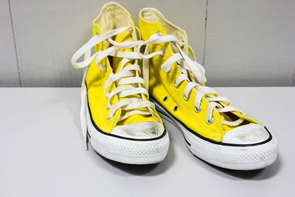 Žluté boty na dřevěnou podlahu — Stock fotografie