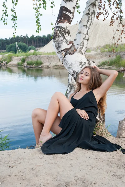 Hermosa dama elegante en vestido abierto descansando cerca del lago — Foto de Stock