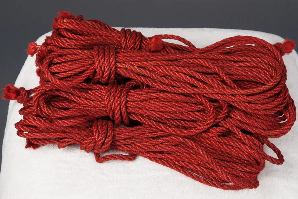 Skeins of red ropes for bondage — Stock Photo, Image