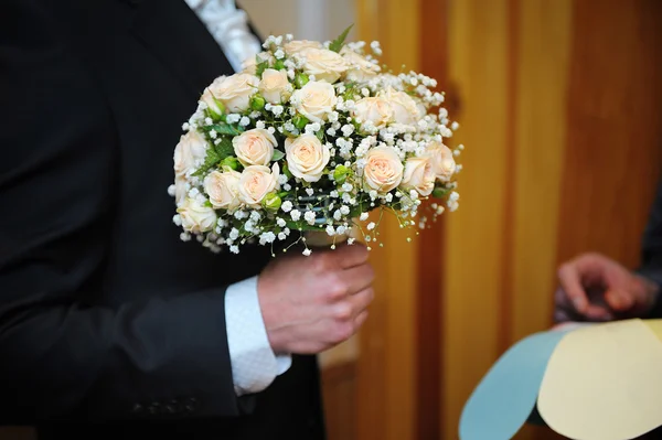 Wedding bouquet with flowers in hands of groom — Stock Photo, Image