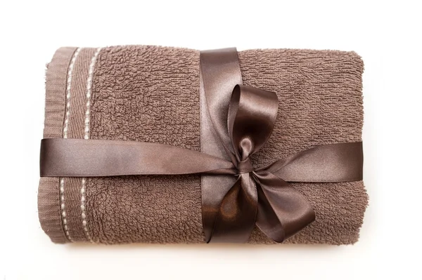 Brown towel tied with a ribbon and bow — Stock Photo, Image