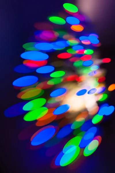Festive colorful bokeh on a dark background — Stock Photo, Image