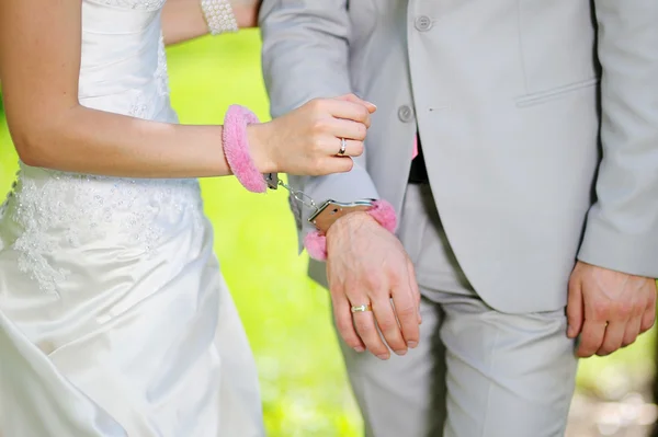 Hands of man and woman bride groom in handcuffs — Stock Photo, Image