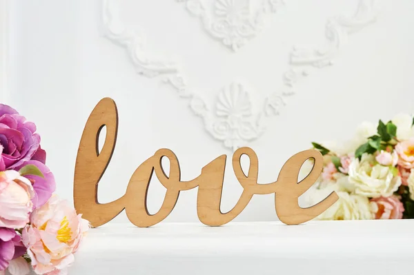 Wooden word Love against white wall in the studio — Stock Photo, Image