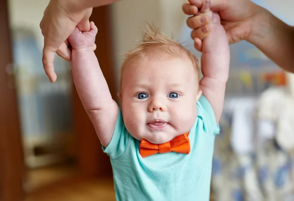 Mother teaching her cute little son to walk holding hands body part first baby steps concept — Stock Photo, Image