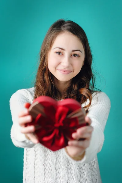 Valentine Day concept. Beautiful young smiling woman with gift in form of heart — Stock Photo, Image