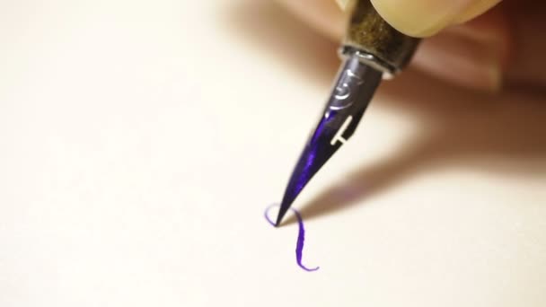 Female hand writes a pen calligraphic signs close up — Stock Video