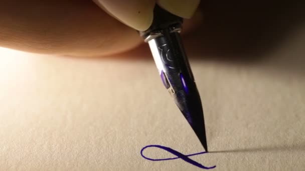 Female hand writes a pen calligraphic signs close up — Stock Video