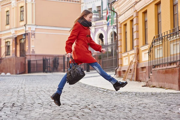 Joven hermosa mujer en abrigo rojo en la ciudad — Foto de Stock