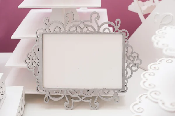 Vintage white frame on a table and place for text — Stock Photo, Image