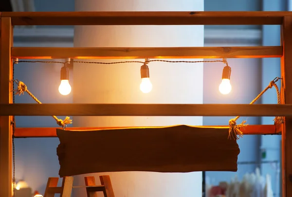 Wooden plate illuminated light bulbs with place for your text — Stock Photo, Image