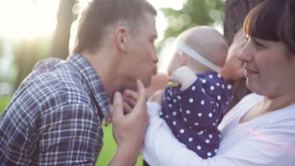 Gelukkige jonge familie tijd samen doorbrengen buiten in groene zomer park — Stockvideo