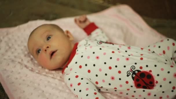 Κοριτσάκι το μωρό ξαπλωμένο σε ένα κρεβάτι — Αρχείο Βίντεο