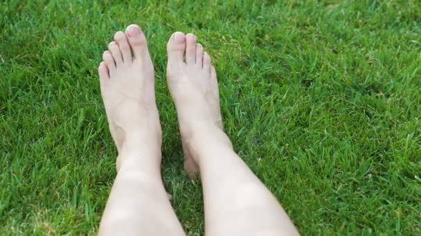 Closeup of a female feet with white french pedicure on nails — Stock Video