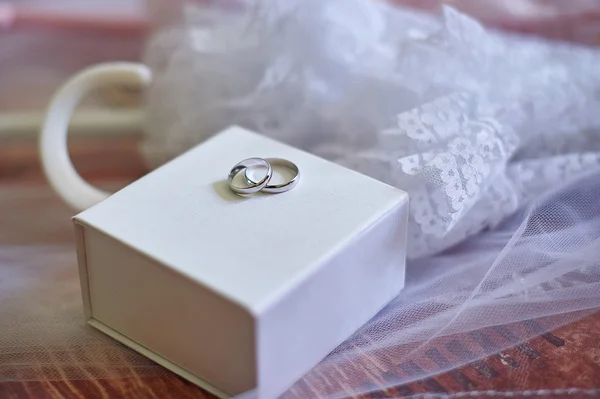 Two wedding rings made of white gold on box — Stock Photo, Image