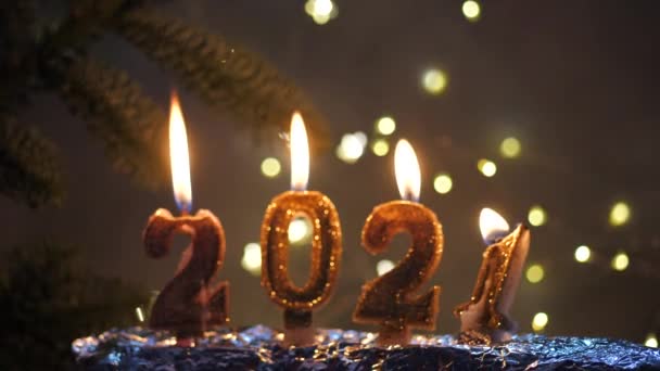 休日の背景ハッピーニューイヤー2021.赤いお祝い輝く背景に金のろうそくを燃やすことによって作られた2021年の桁。新年の休日、クローズアップを祝う。テキストのスペース — ストック動画