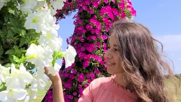 Primer plano mujer adulta jardinero olfateando la floración en su patio. Madura dama alegre y flores de arbusto. mujer empleada de verano en su jardín disfruta de la naturaleza. Full HD movimiento de vídeo — Vídeos de Stock