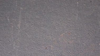 Siyah gri sert beton duvar geniş dokusu. İnce desenli beton alçı yüzeyinde küçük çatlaklar var. Koyu gri grunge arkaplanı