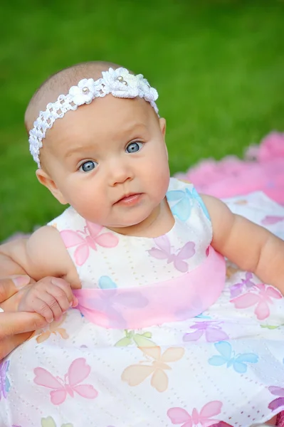 Portrait of a little girl in wreath of flowers — Stock Photo, Image