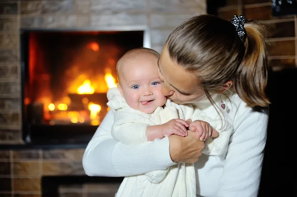 Mutter mit Baby am heimischen Kamin — Stockfoto