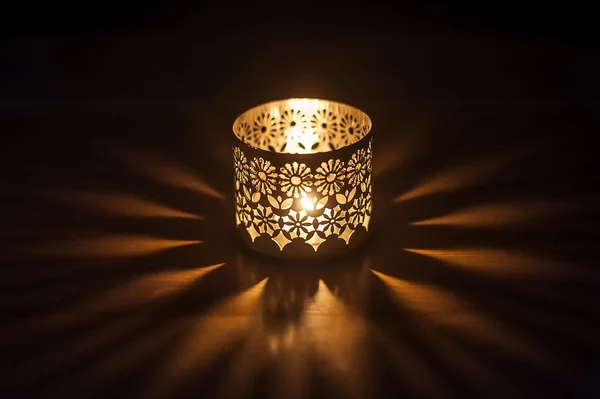 Lighted candle in a candlestick — Stock Photo, Image