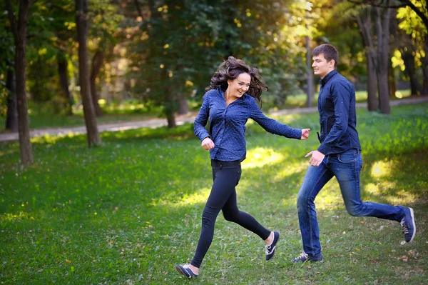 Couple in love in the park runs — Stock Photo, Image
