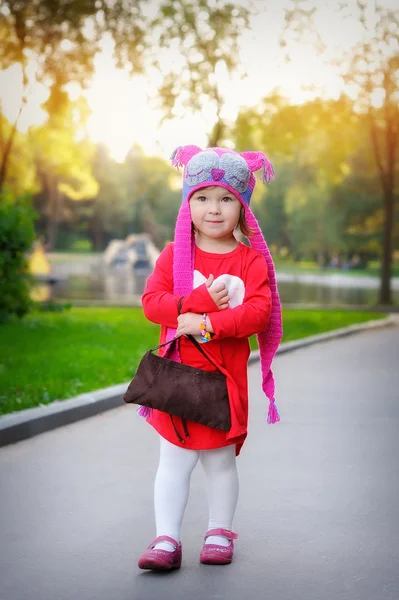 Little girl in a knitted hat autumn owls — Stock Photo, Image