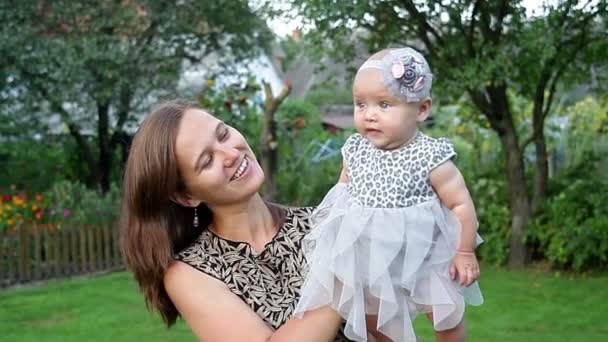 Young mother with child outside on a summer day — Stock Video