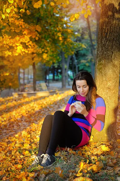 Beautiful woman spending time in park during autumn season — Stock Photo, Image