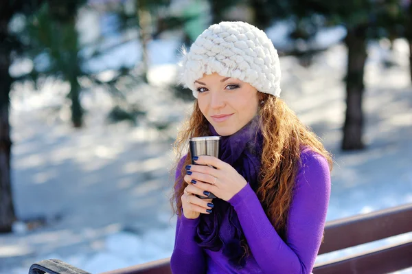 Winter girl drinking warm beverage — Stock Photo, Image