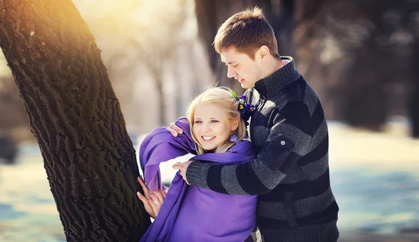 Loving couple in winter, boy care warms Woman scarf — Stock Photo, Image