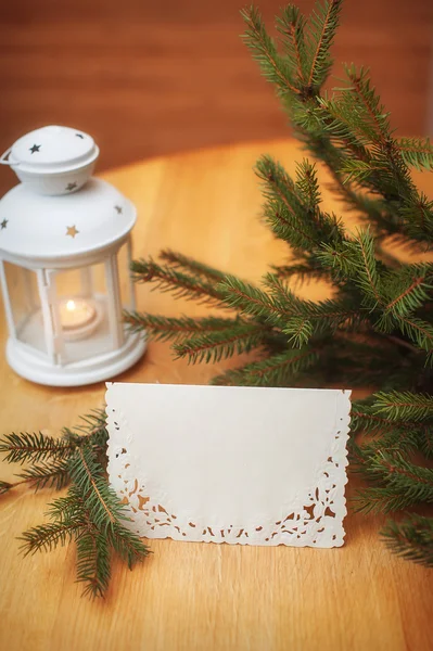 Christmas lantern with fir and snow on vintage wooden background — Stock Photo, Image