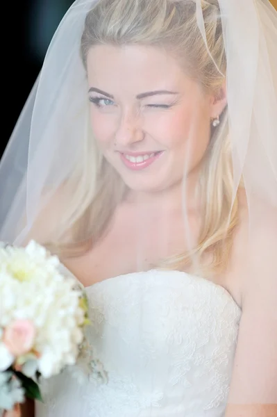 Beautiful blonde bride winking eye — Stock Photo, Image