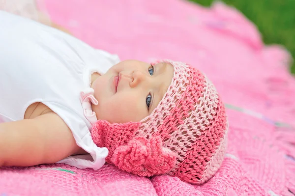 Baby girl in pink knitted hat — Stock Photo, Image