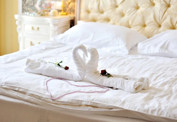 Swans out of towels on the bed — Stock Photo, Image