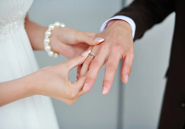 Невеста носит золотое кольцо на свадьбу жениха — стоковое фото