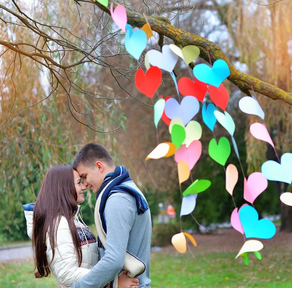 Young woman and man in the decoration of the heart, on the feast — Stock Photo, Image