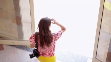 Otelden bir fotoğraf makinesi ile güzel kız gelir