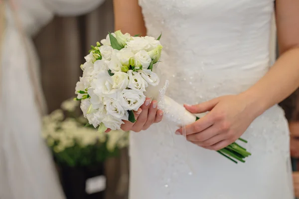 Bride holding wedding bouquet of white flowers — Stock Photo, Image