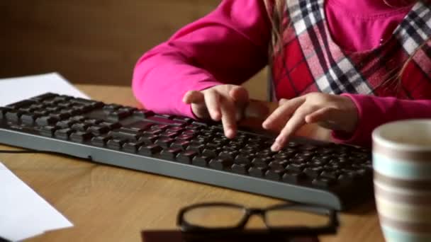 Маленька дівчинка друкує на клавіатурі — стокове відео