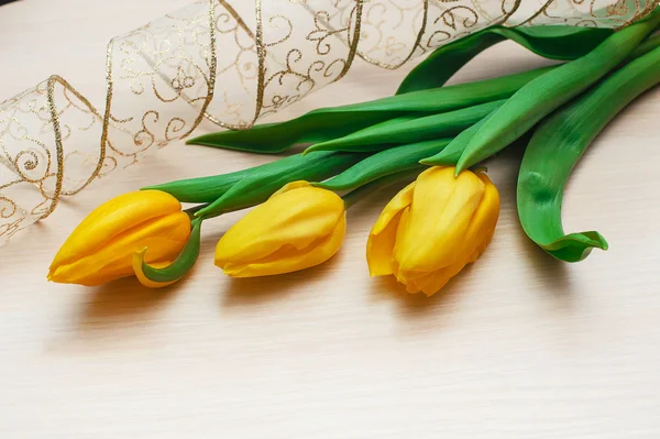 Three tulips and beautiful delicate ribbon — Stock Photo, Image