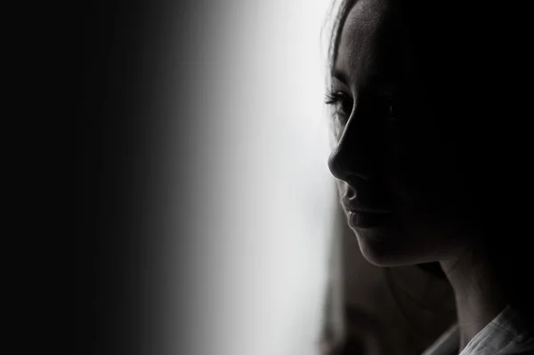 Beautiful girl looking out the window — Stock Photo, Image