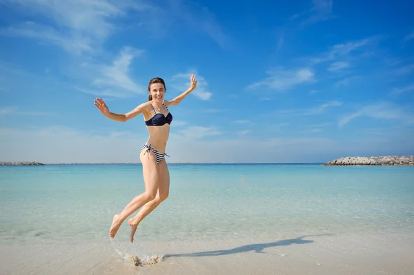 Bright picture of happy jumping woman on the beach — Stock Photo, Image