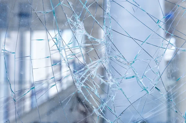 Cracked glass in a shop window closeup — Stock Photo, Image