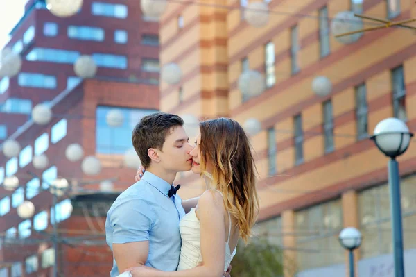 Happy bride and groom walking on a street of city — Stock Photo, Image