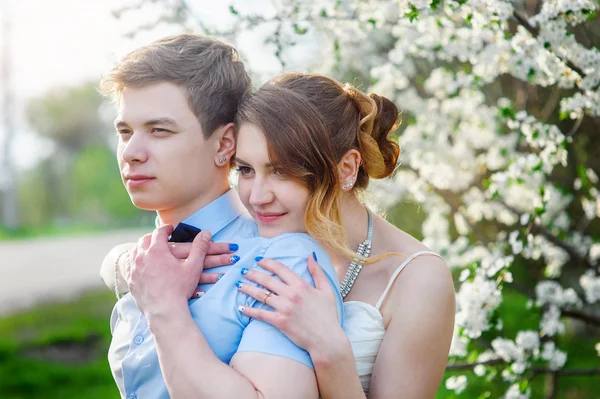 Nevěsta a ženich v jarní parku objímání — Stock fotografie