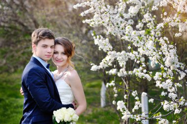 Bahar çiçek açan bahçede yürüyüş güzel yeni evliler